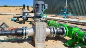 Evolved progressive cavity biogas pump by Kronoa Engineered Solutions installed outdoors at a biogas production plant, showing the heavy-duty suction housing, mechanical drive, and green piping system.